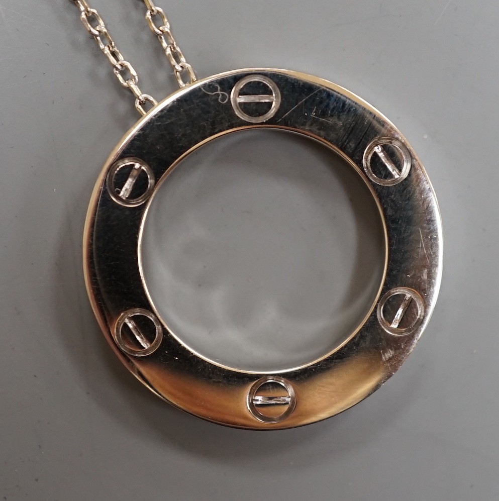 A modern Italian Cartier 750 white metal 'Love' circular pendant, 24mm, numbered CRD612779, on a 750 white metal fine link chain, 46cm, 10.8 grams.